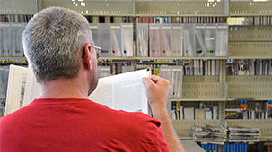 Over the shoulder shot of student reading book.