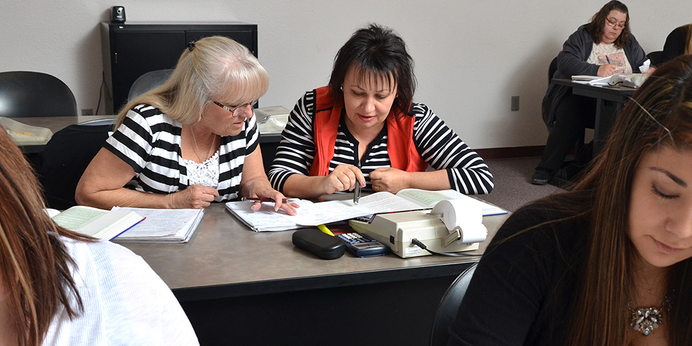 Students helping each other in accounting class.