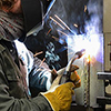 Student performing a butt weld at a testing station.