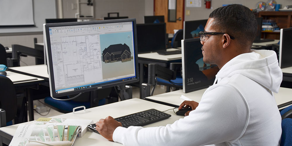 Students working on drafting projects at computer stations in the drafting lab.