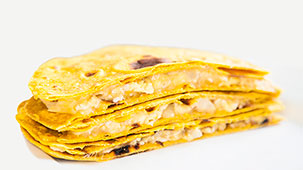Stack of three chicken and cheese quesadillas.