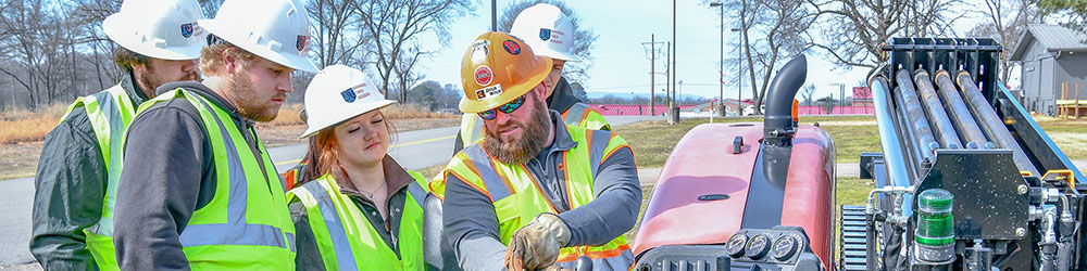Group of student learning how to operate a horizontal directional drill.