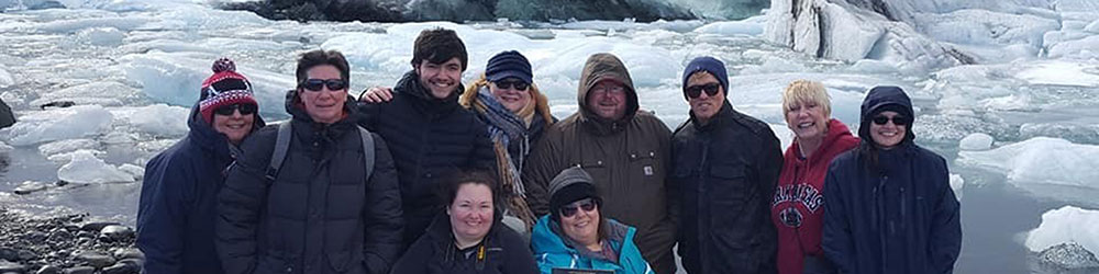 Group of students and employees posing for picture at Glacial Lake.