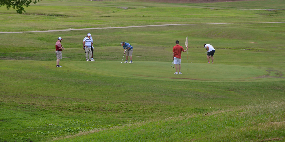 Golfers on golf course.