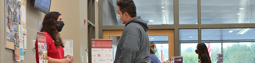 Students meeting with college recruiters at their booths set up in the lobby of the University Center.