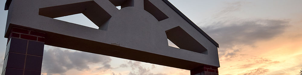 Student Union Courtyard arch viewed against colorful morning sky.